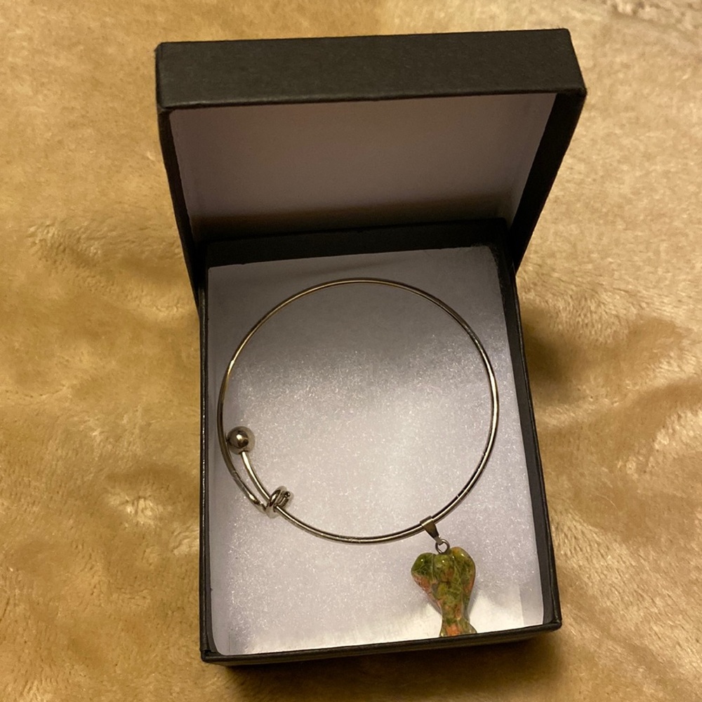 New in box adjustable silver bracelet with angel charm made from stone.